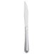 A Libbey Cortland stainless steel steak knife with a fluted solid handle.