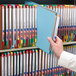 A hand holding a blue Smead file folder.