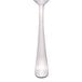 A Libbey stainless steel teaspoon with a white handle.