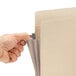 A hand opening a Smead file pocket with a paper inside.
