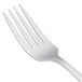 A close-up of a Libbey Cortland dessert fork with a white handle.