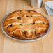 An American Metalcraft aluminum pie pan filled with a lattice-topped pie on a table.