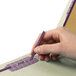 A hand holding a purple Smead pencil