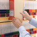 A hand holding a Smead Shelf-Master file folder with divider and fasteners.