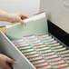 A person opening a file drawer with Smead file folders.