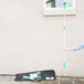 A woman holding a bag with a green and white Unger ErgoTec window cleaning tool kit.