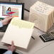 A person holding a Smead file folder with papers inside.