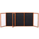 A black board with a wooden frame and three black panels.