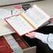 A person holding a Smead file folder with papers.