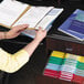 A woman opening a Smead file drawer filled with file folders.