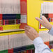 A person holding a Smead yellow Shelf-Master file folder.