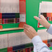 A person holding a Smead green Shelf-Master file folder.