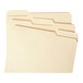 A group of Smead file folders with standard Manila tabs in three different colors.