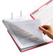 A person's hand holds a red Smead Shelf-Master folder with papers.