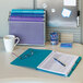 A desk with a Smead SuperTab organizer, folders, and pens.