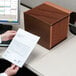 A person holding a paper next to a brown Smead TUFF legal file folder.