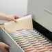 A hand opening a file drawer with Smead file folders inside.