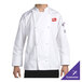 A person wearing a white Chef Revival chef's coat with a purple logo.