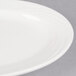 A CAC Garden State bone white porcelain platter with a wavy rim.