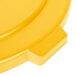 A close up of a yellow Carlisle Bronco lid with a handle.