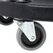 A Carlisle black plastic dolly with wheels.