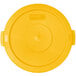 A yellow plastic lid with a small dot in the center.