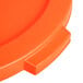 An orange plastic lid for a Carlisle Bronco trash can.