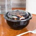 A clear Sabert bowl of salad with a clear plastic lid and a plastic fork.