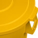 A close up of a yellow Carlisle Bronco lid on a yellow plastic trash can.