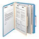 A blue Smead classification folder with papers in it.