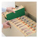 A hand holding a Smead green file folder.