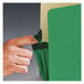 A hand holding a green Smead legal file pocket with a black and white label