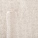 A close up of a white fabric with a small hole.