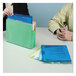 A man and woman using Smead poly file jackets to organize files at a table.
