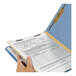 A hand holding a Smead file folder with a document inside.