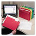 A person holding a red Smead file folder with different colored files.