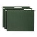 Three green file folders with Smead white tabs inserted into the clear tabs.