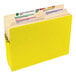 A yellow Smead file pocket with tabs and labels.