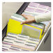 A hand holding a yellow Smead file folder.