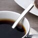 A Chef & Sommelier Kya stainless steel demitasse spoon in a cup of coffee.