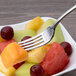 A Chef & Sommelier stainless steel dessert fork in a bowl of fruit.