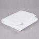 a folded white sheets on a gray surface