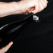 A person using a Laguiole champagne saber to open a bottle of wine.