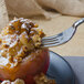 A Libbey stainless steel utility/dessert fork with caramel and nuts on a plate.