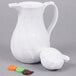 A white pitcher with a lid.