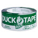 A roll of silver Duck Tape with a duck logo on a white background.