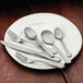 A white plate with a Libbey European dinner fork and knife on it.