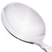 A close-up of a Libbey stainless steel bouillon spoon with a white handle.