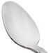 A close-up of a Libbey stainless steel demitasse spoon with a silver handle.