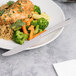 A knife on a plate of vegetables.